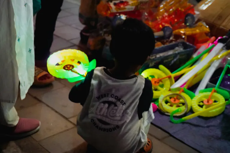 Child holding a glowing cartoon character lantern