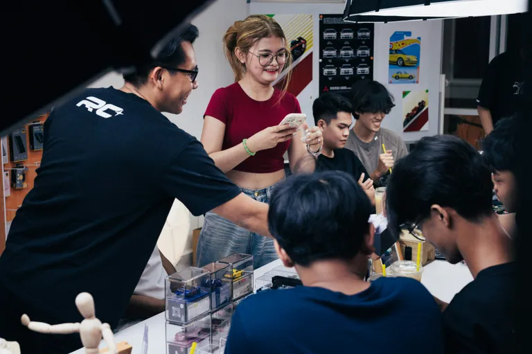 People gathered around a table, possibly working together.