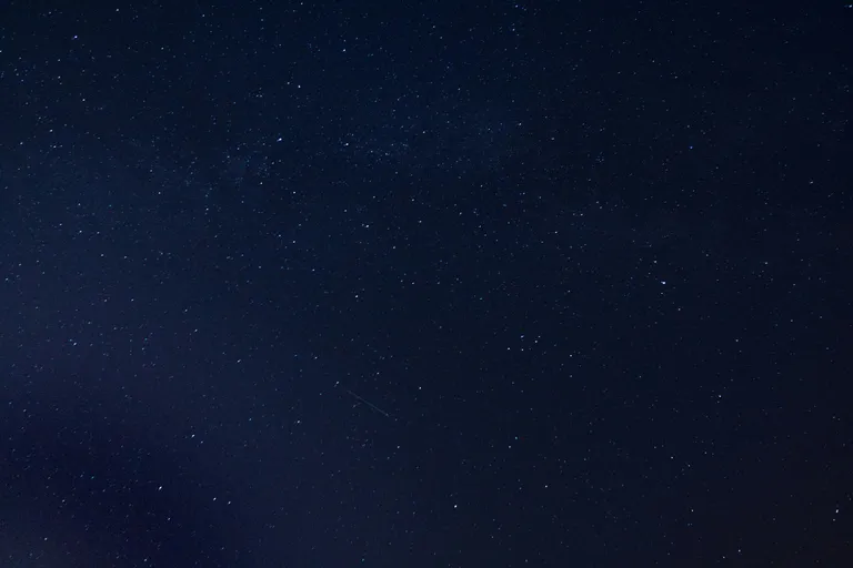 the night sky is full of stars and a few clouds