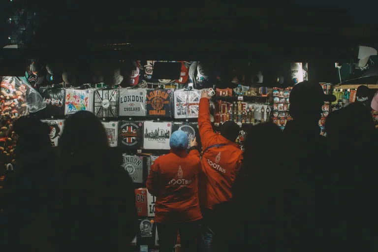 a group of people standing in front of a wall